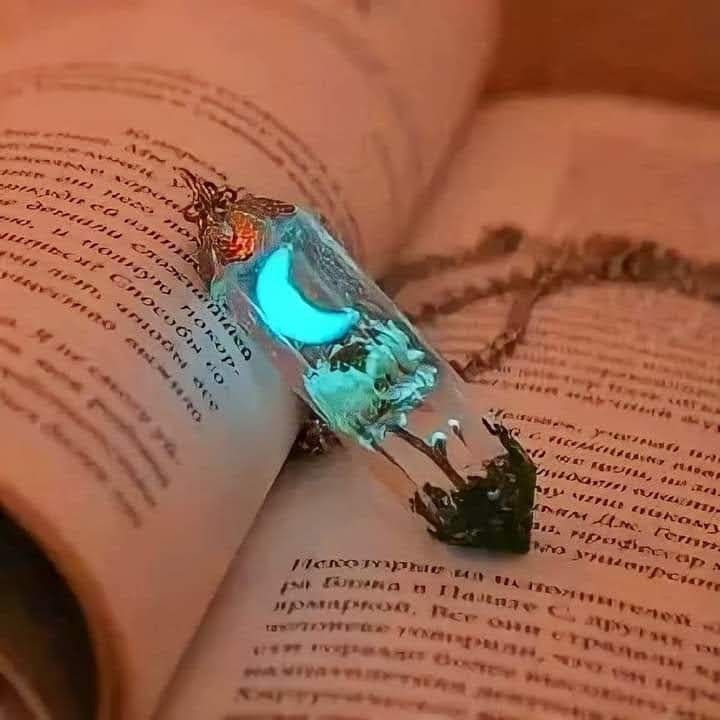 glowing-resin-moon-pendant-on-book