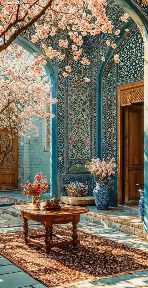 حیاط ایرانی با شکوفه‌های بهاری و کاشی‌کاری فیروزه‌ای